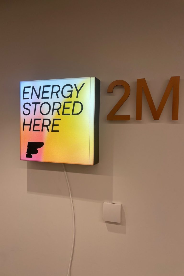 Office signage and graphic decal | The Vinyl Bay Vinyl office sign in a light box.